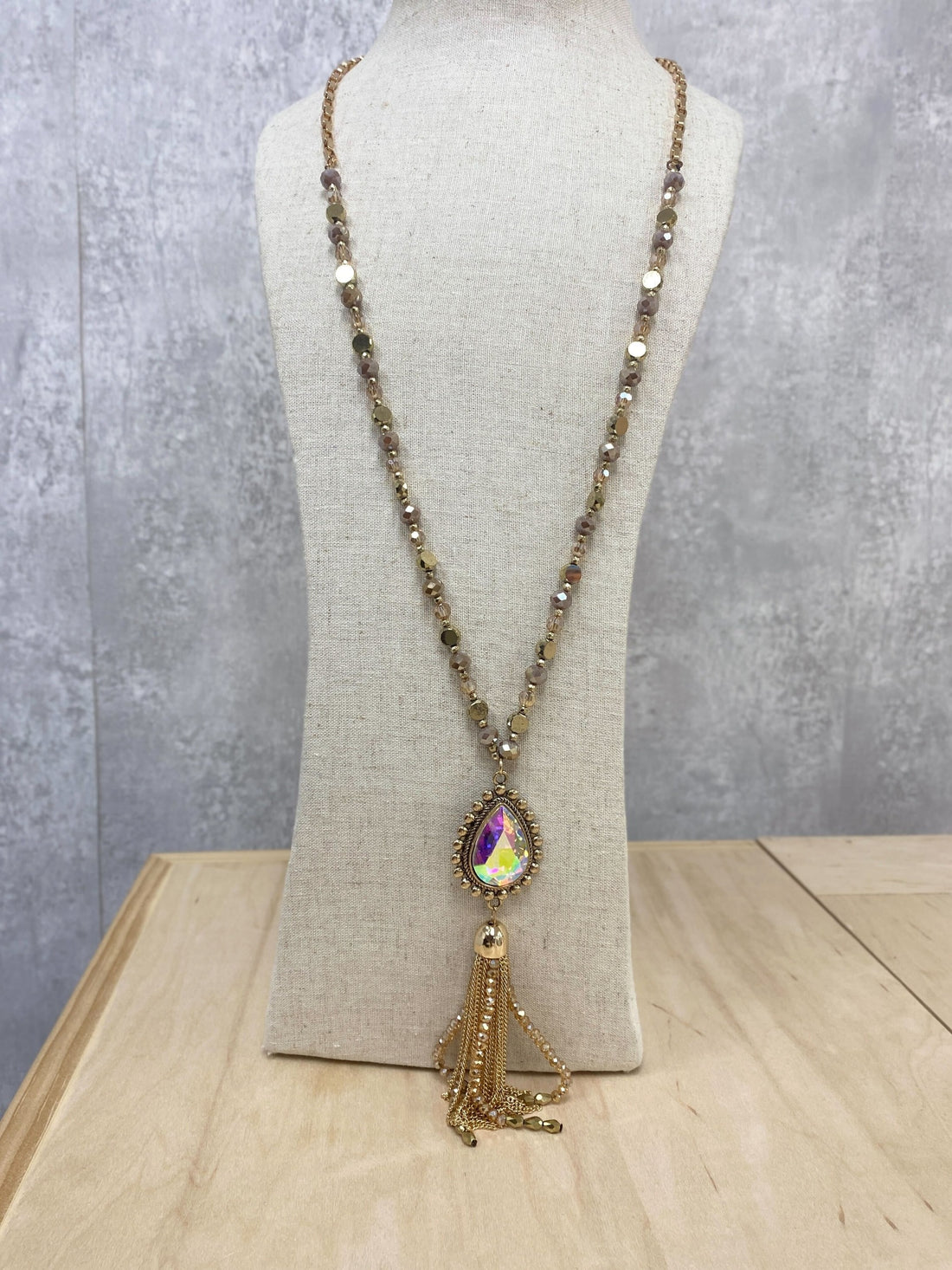 SHINE SO BRIGHT IRIDESCENT OVAL PENDANT GOLD CHAIN TASSEL ON A CRYSTAL BEADED GOLD CHAIN NECKLACE, BROWN